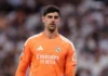 Courtois Absen di El Clasico karena Flu, Lunin Jadi Starter Thibaut Courtois mengenakan seragam kiper Real Madrid berwarna oranye
